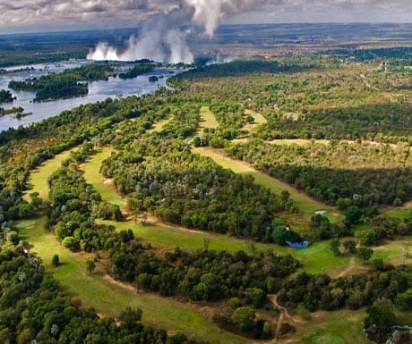 Golf greens with the mighty Victoria Falls in the backdrop  golf safaris in Africa offer adventure and leisure, all on African soil