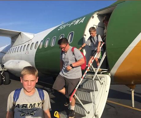 Kids getting off plane