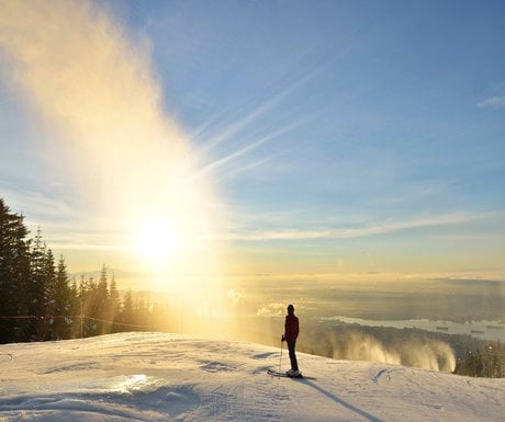 Lady Skier enjoy sunrise on Grouse Mountain