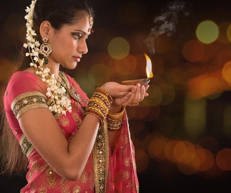 Indian girl hands holding diwali lights