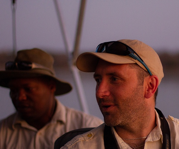 Man on boat safari Zimbabwe by Alex Walters