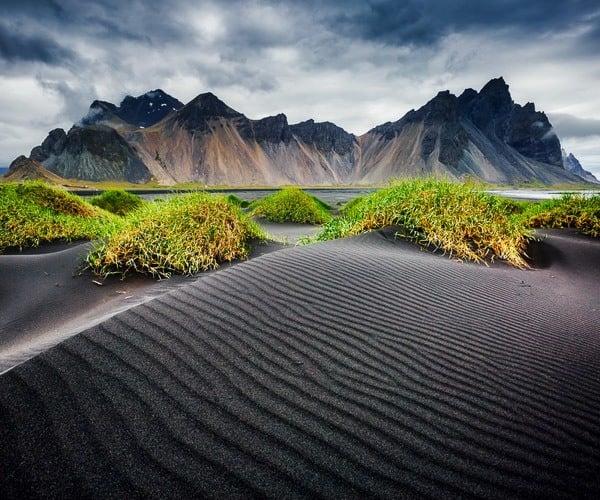 Rippled black sand beach backdropped by the impressive Vestrahorn mountain in Stokksnes cape in springtime, East Iceland