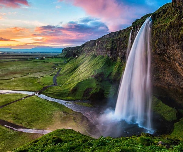 Seljalandsfoss waterfall, a perfect location to enjoy summer's midnight sun in South Iceland