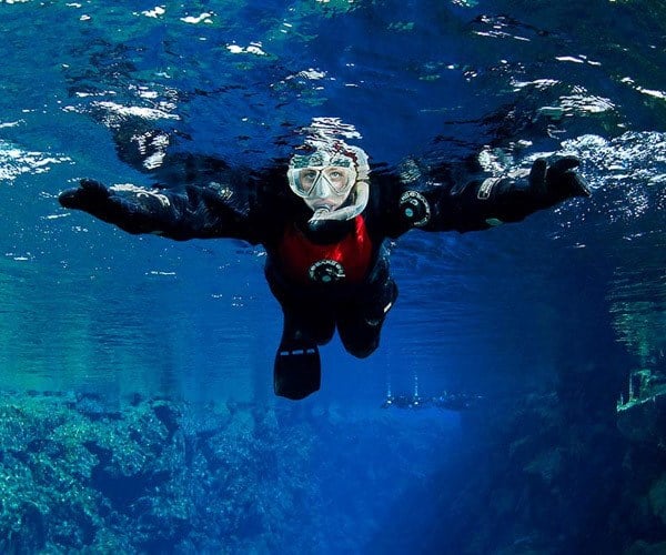 Snorkling in World's clearest water at Silfra Fissure, Thingvellir National Park, Iceland