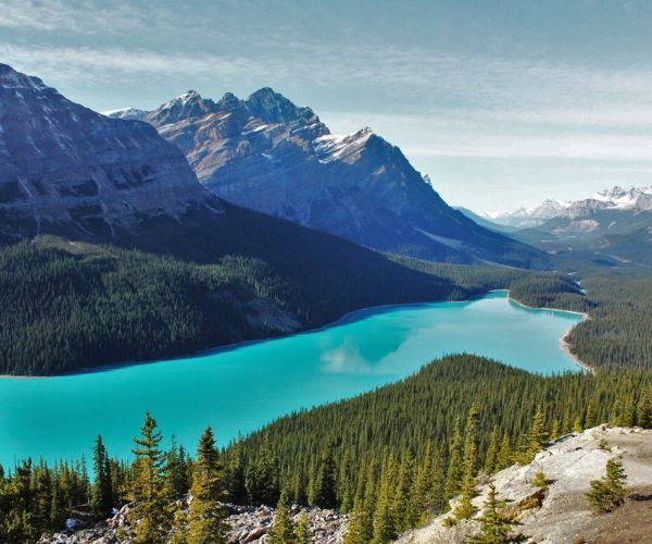 Turquoise Lake surrounded by green forest and mountain