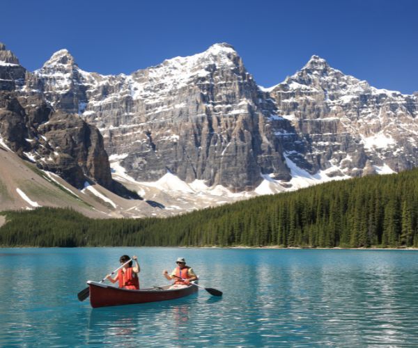 Two people in a canoe on a beautiful blue lake