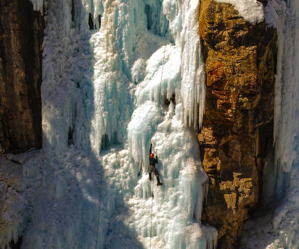 A man climbing an icy mountain in Ouray