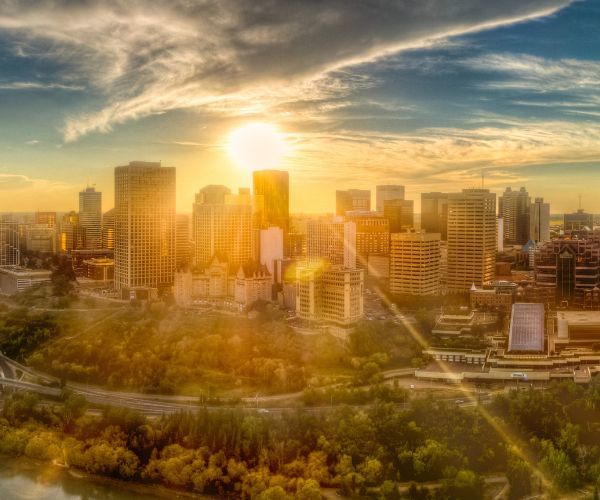 The sun setting behind buildings in Edmonton