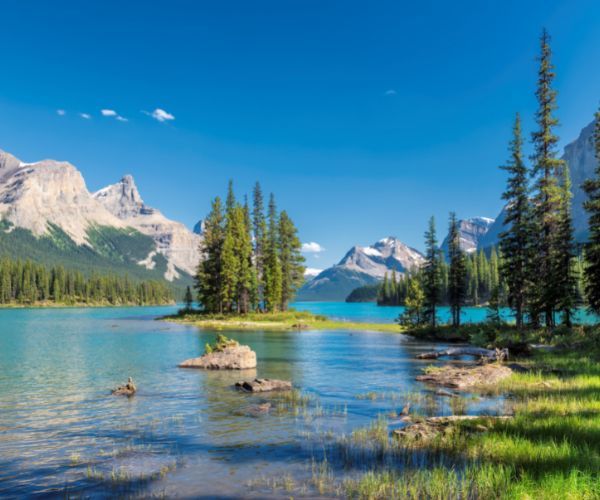 Clear blue lake and snow capped peaks in Jasper National Park