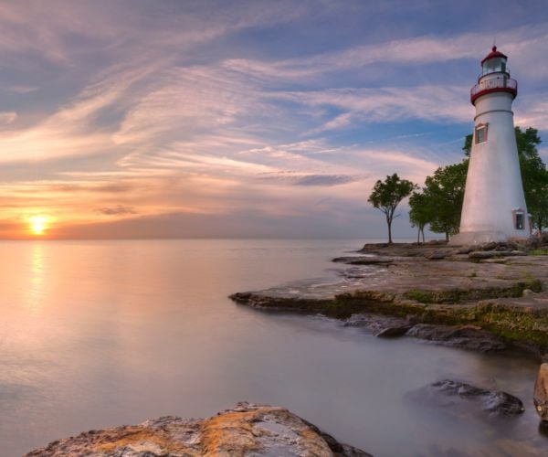 A lighthouse at Erie Lake at sunset